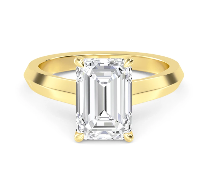 Emerald solitaire engagement ring with a plain yellow-gold band